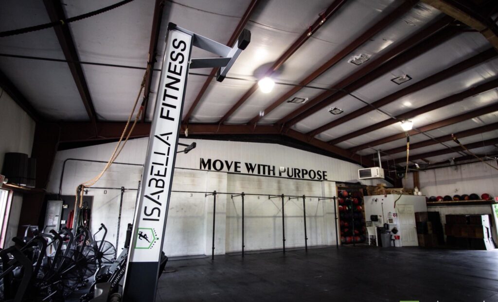 The open training floor with rowers, the rig and the class in session