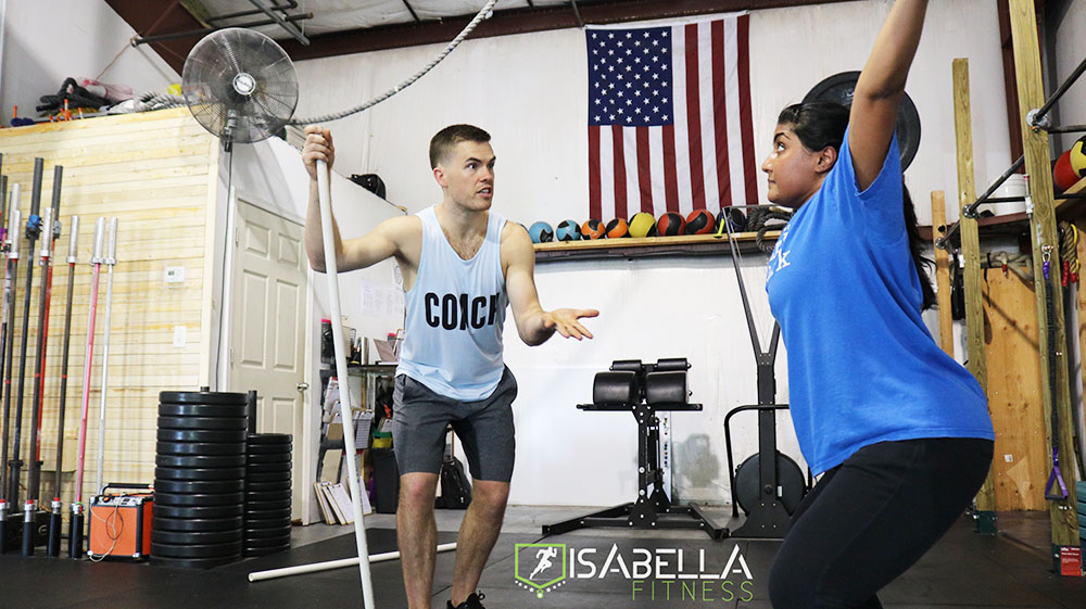 A coach working one-on-one with a member at Isabella Fitness