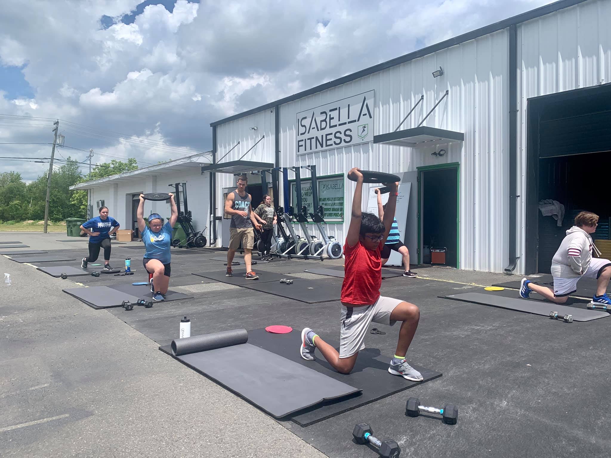 Youth class training together outside Isabella Fitness
